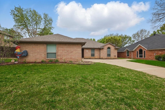 ranch-style house with a front yard, driveway, and brick siding