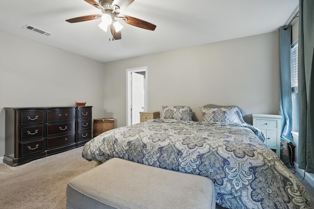 bedroom featuring multiple windows, visible vents, a ceiling fan, and carpet floors