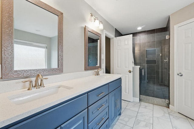 bathroom featuring marble finish floor, a sink, a shower stall, and double vanity