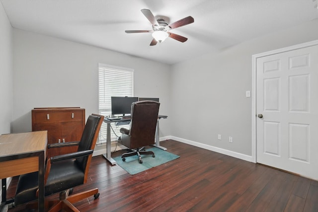office area with baseboards, ceiling fan, and dark wood-style flooring