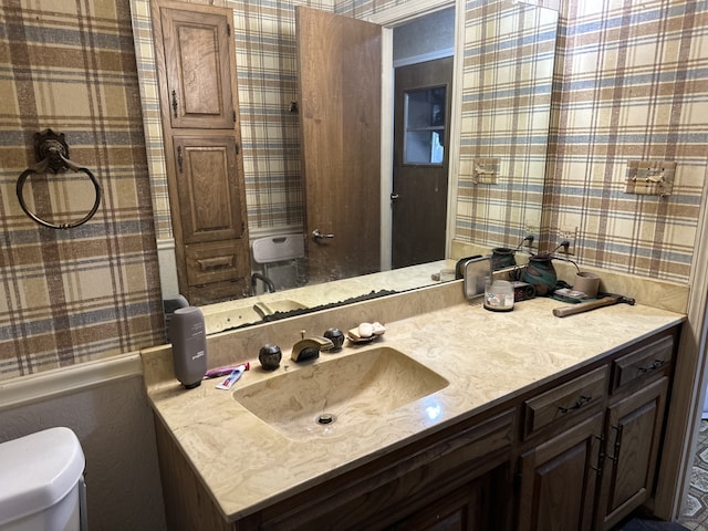 bathroom featuring toilet and vanity