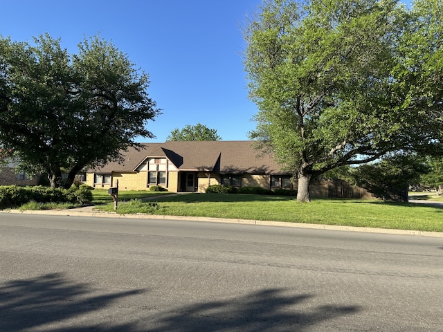 tudor house featuring a front lawn