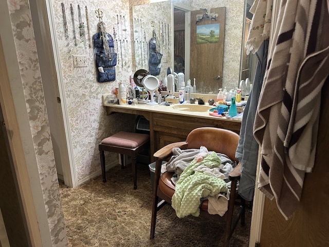 bathroom with wallpapered walls and vanity