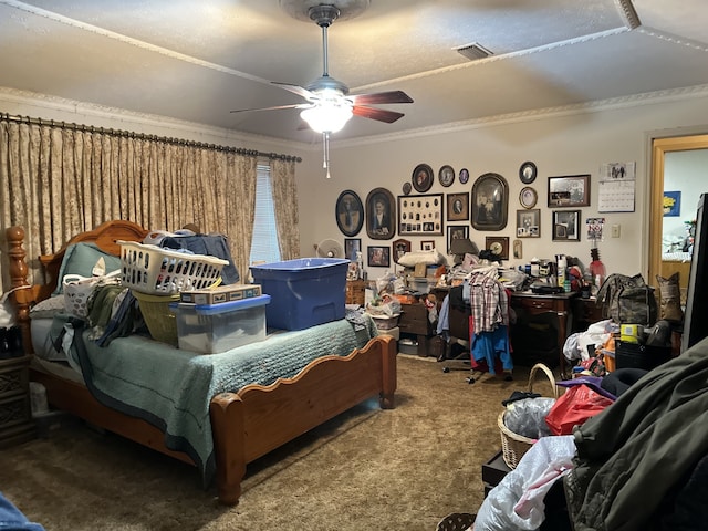 carpeted bedroom featuring visible vents, ceiling fan, and crown molding