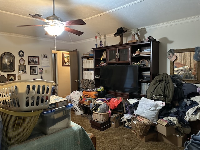 living area featuring a ceiling fan, crown molding, and carpet floors