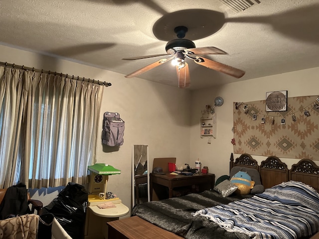 bedroom featuring visible vents, ceiling fan, and a textured ceiling
