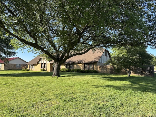 view of yard with fence, an outdoor structure, and a barn