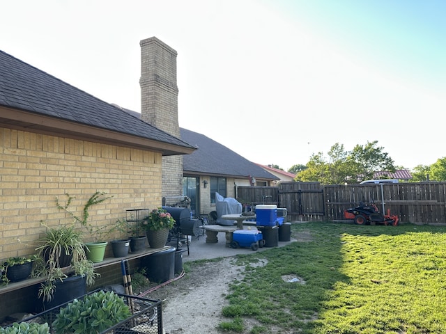 view of yard featuring a patio and fence