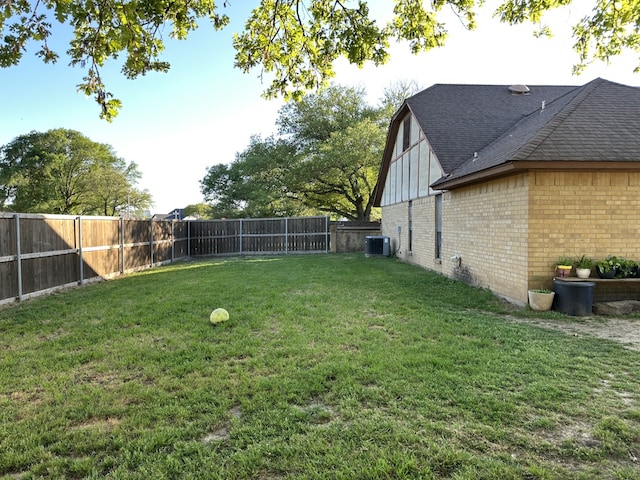 view of yard featuring central AC unit and a fenced backyard