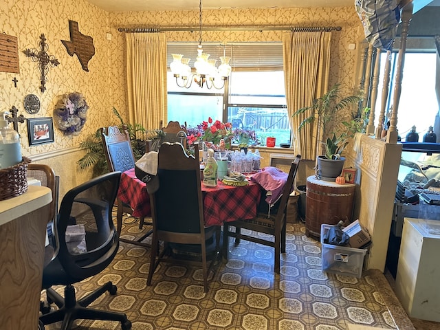 dining room with a notable chandelier and wallpapered walls