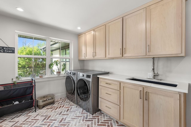 laundry area with independent washer and dryer, a sink, recessed lighting, cabinet space, and brick floor