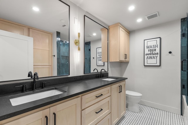 full bath featuring an enclosed shower, a sink, tile patterned floors, and visible vents