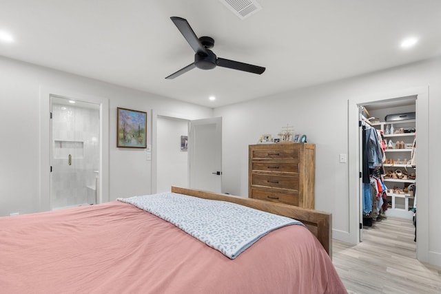 bedroom featuring visible vents, light wood-style floors, a closet, recessed lighting, and a spacious closet