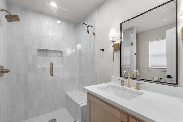 bathroom with vanity and a shower stall