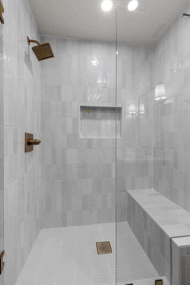 bathroom featuring a tile shower and recessed lighting