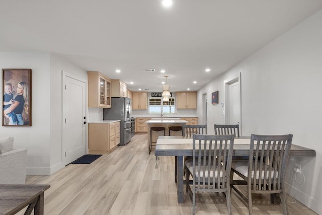 dining room featuring baseboards, visible vents, light wood-type flooring, and recessed lighting