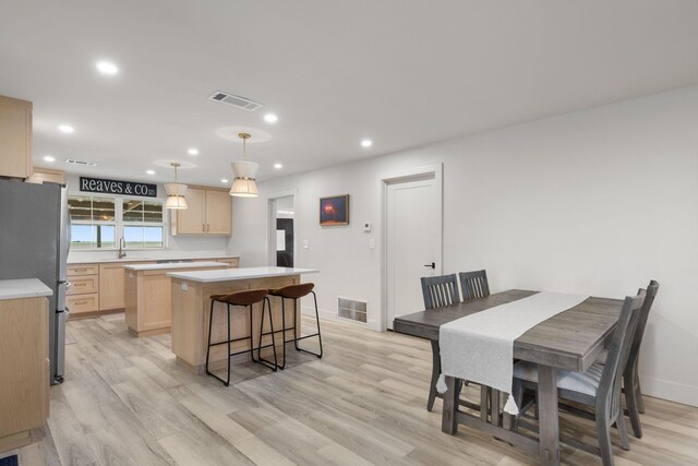 dining room featuring visible vents and light wood-style floors