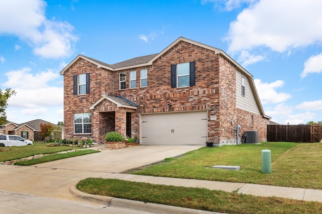 traditional-style house with brick siding, fence, a garage, a front lawn, and concrete driveway