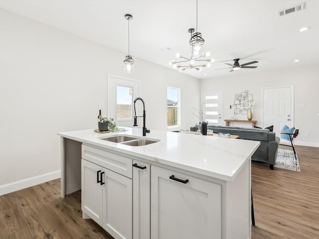 8008 W Elizabeth Ln, Fort Worth, TX 76116 - kitchen with pendant lighting, visible vents, light wood-type flooring, and a sink