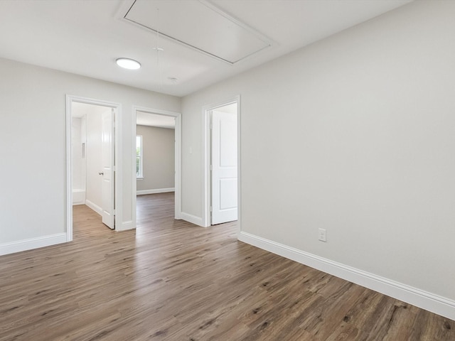 8008 W Elizabeth Ln, Fort Worth, TX 76116 - spare room featuring baseboards, attic access, and wood finished floors