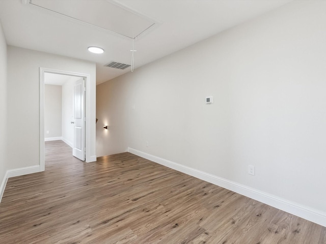 8008 W Elizabeth Ln, Fort Worth, TX 76116 - empty room with baseboards, visible vents, attic access, and wood finished floors