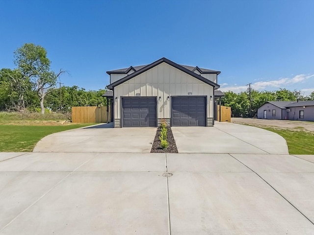 8008 W Elizabeth Ln, Fort Worth, TX 76116 - view of side of property with driveway, board and batten siding, a lawn, an attached garage, and fence