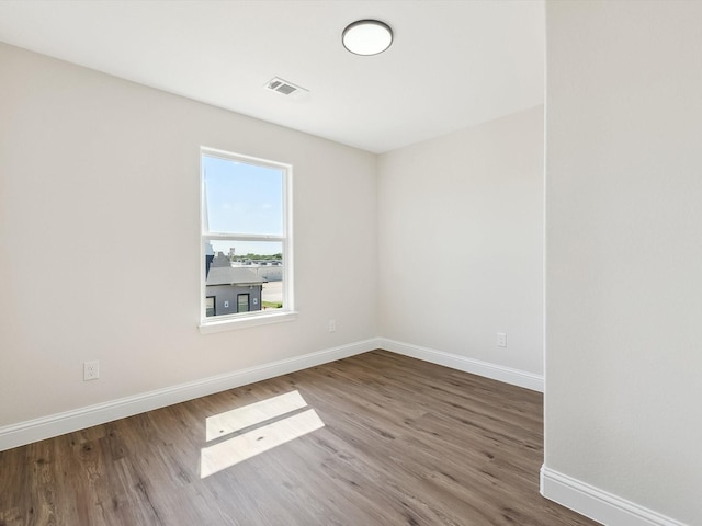 8008 W Elizabeth Ln, Fort Worth, TX 76116 - spare room featuring wood finished floors, visible vents, and baseboards