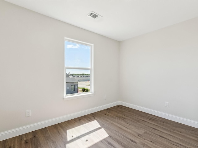 8008 W Elizabeth Ln, Fort Worth, TX 76116 - spare room with wood finished floors, visible vents, and baseboards
