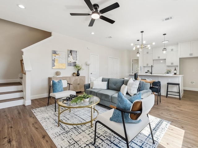 8008 W Elizabeth Ln, Fort Worth, TX 76116 - living room with light wood-type flooring, baseboards, recessed lighting, and ceiling fan with notable chandelier