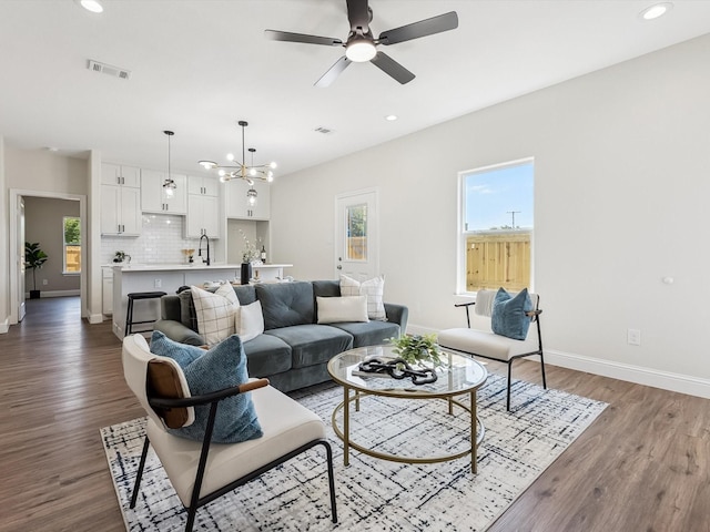 8008 W Elizabeth Ln, Fort Worth, TX 76116 - living area with baseboards, visible vents, ceiling fan with notable chandelier, and dark wood-type flooring