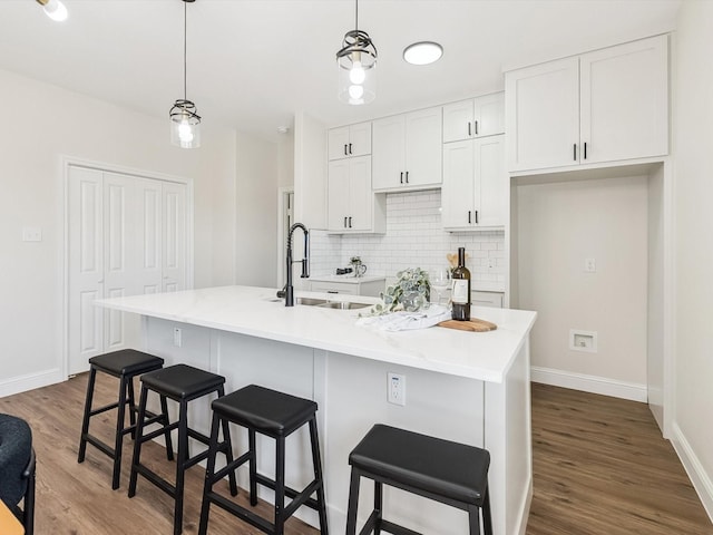 8008 W Elizabeth Ln, Fort Worth, TX 76116 - kitchen with a sink, decorative backsplash, white cabinetry, baseboards, and dark wood finished floors