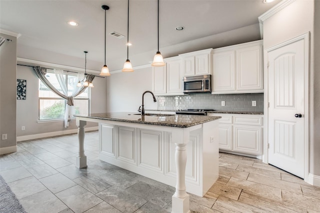 kitchen with stainless steel microwave, a sink, tasteful backsplash, and baseboards