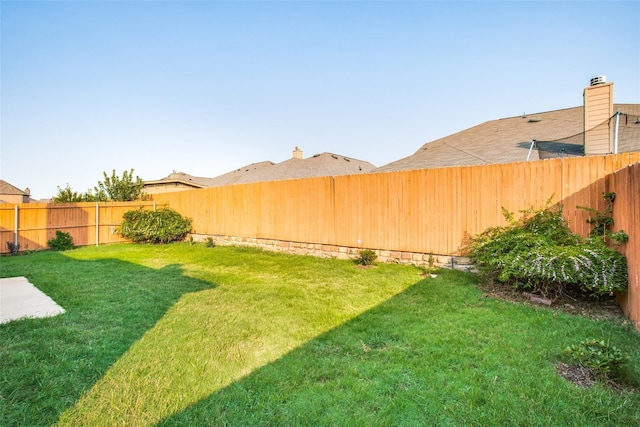 view of yard with a fenced backyard