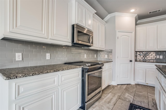kitchen featuring tasteful backsplash, stainless steel appliances, white cabinets, visible vents, and crown molding
