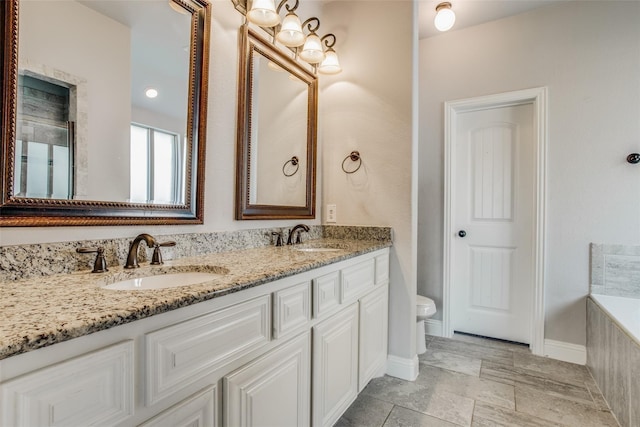 full bath with a bath, toilet, double vanity, and a sink
