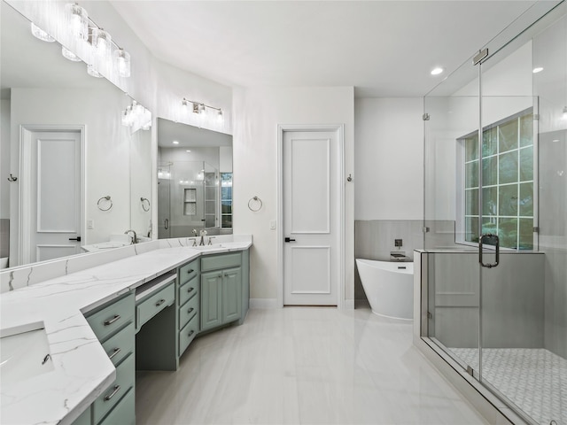 bathroom with double vanity, a freestanding tub, a shower stall, and a sink