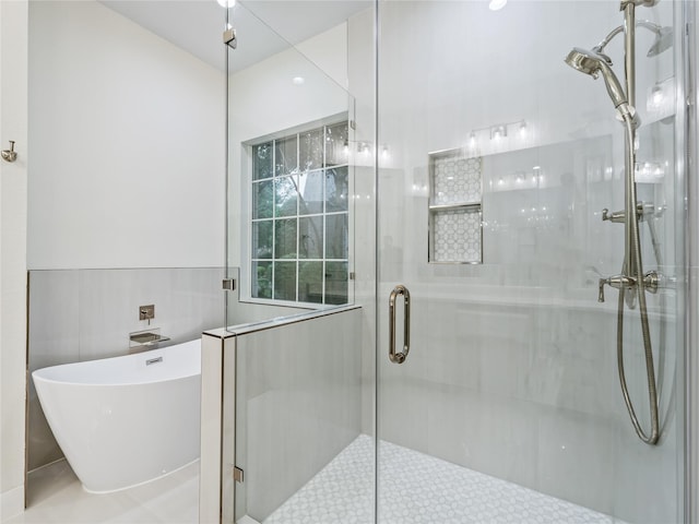 bathroom with a freestanding bath and a shower stall