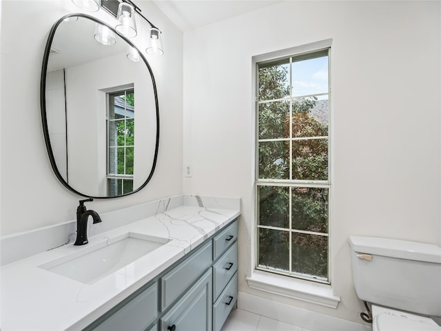 bathroom with vanity, tile patterned floors, and toilet