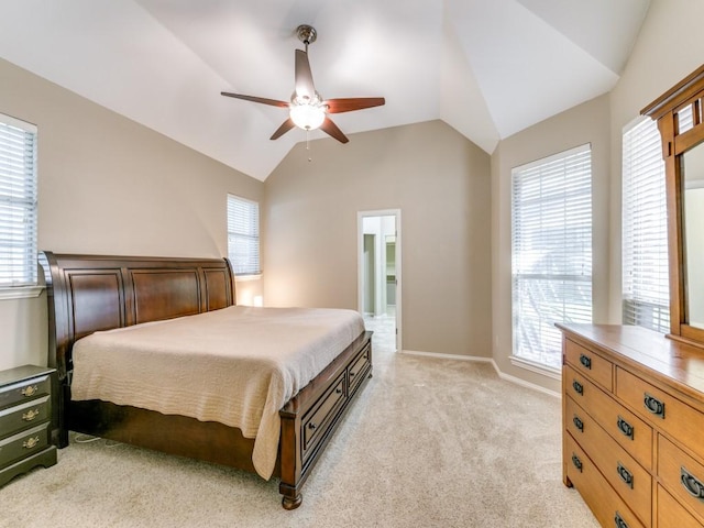 bedroom with light colored carpet, multiple windows, ceiling fan, and lofted ceiling