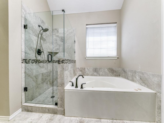 full bathroom with a bath and a shower stall