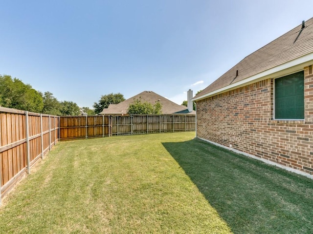 view of yard with a fenced backyard