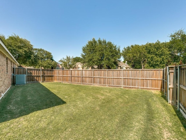 view of yard with cooling unit and a fenced backyard