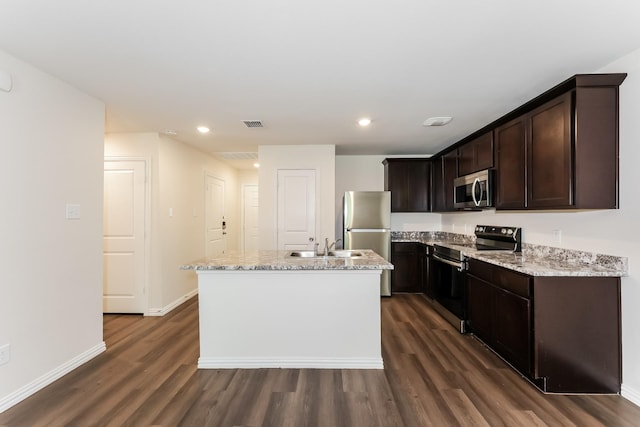 932 Dawson St, Waco, TX 76704 - kitchen featuring appliances with stainless steel finishes, dark wood-style flooring, a kitchen island with sink, and dark brown cabinets