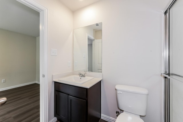 932 Dawson St, Waco, TX 76704 - bathroom with toilet, wood finished floors, vanity, and baseboards