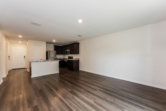 932 Dawson St, Waco, TX 76704 - kitchen with fridge, visible vents, stainless steel microwave, and baseboards