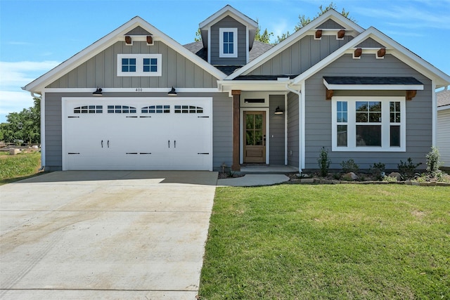 craftsman-style home with board and batten siding, a shingled roof, driveway, a front yard, and an attached garage