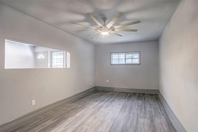 4301 Wilhelm St, Fort Worth, TX 76119 - empty room featuring wood finished floors, a ceiling fan, visible vents, and baseboards