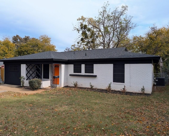 4301 Wilhelm St, Fort Worth, TX 76119 - ranch-style home featuring roof with shingles, central AC unit, a front yard, and brick siding