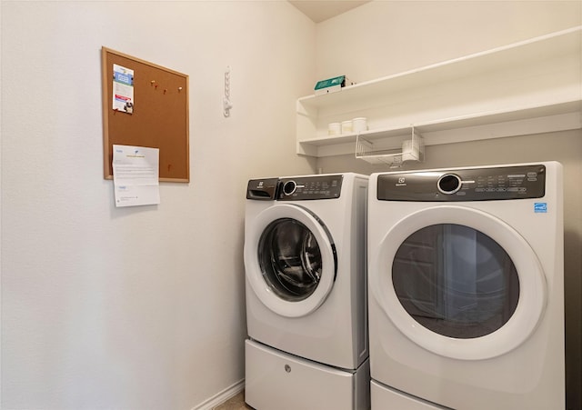 washroom featuring laundry area and washer and clothes dryer