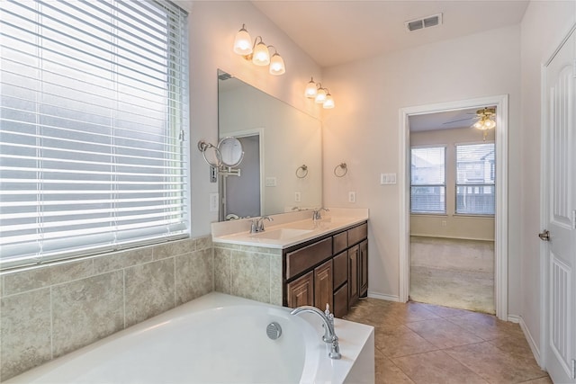 full bathroom with visible vents, a bath, tile patterned flooring, and a sink